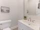 Stylish half bathroom with white vanity, sink, and decorative mirror at 9451 Bonnie Briar Cir, Charlotte, NC 28277