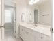 Bright bathroom featuring a white vanity with a large mirror and a separate toilet area at 9451 Bonnie Briar Cir, Charlotte, NC 28277