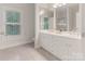Elegant bathroom with double vanity, large mirrors, and a window with shutters at 9451 Bonnie Briar Cir, Charlotte, NC 28277
