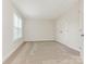 Neutral bedroom with a large window providing natural light and a double door closet at 9451 Bonnie Briar Cir, Charlotte, NC 28277