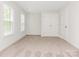 Bedroom featuring neutral carpeting, bright light, and a closet at 9451 Bonnie Briar Cir, Charlotte, NC 28277