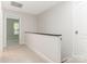 Upstairs hallway with carpet flooring, white trim, and a view into the adjacent bedroom at 9451 Bonnie Briar Cir, Charlotte, NC 28277