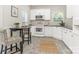 Bright kitchen area with white cabinets, wood tile floor and breakfast table at 9451 Bonnie Briar Cir, Charlotte, NC 28277