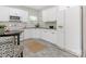 Well-lit kitchen featuring white cabinets, modern appliances, and a cozy breakfast table at 9451 Bonnie Briar Cir, Charlotte, NC 28277