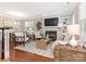 Bright, open living room featuring a fireplace, built-in shelves, and comfortable seating at 9451 Bonnie Briar Cir, Charlotte, NC 28277