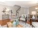 Cozy living room with hardwood floors, a staircase, and adjacent dining area at 9451 Bonnie Briar Cir, Charlotte, NC 28277