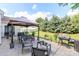 Expansive backyard featuring a patio area, a gazebo, a grill, lush green lawn, and mature landscaping at 1006 Apogee Dr, Indian Trail, NC 28079