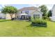 Sprawling backyard featuring a patio area with an outdoor gazebo, grill, lush green lawn, and mature landscaping at 1006 Apogee Dr, Indian Trail, NC 28079