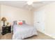 Cozy bedroom featuring neutral-colored walls, ceiling fan, carpet flooring, a double door closet and a queen-sized bed at 1006 Apogee Dr, Indian Trail, NC 28079