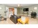 Bonus room with a desk, sofa, television and adjacent doorway to the upstairs hallway at 1006 Apogee Dr, Indian Trail, NC 28079