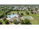 Aerial view of community clubhouse featuring a pool, playground, tennis court, and green lawns at 1006 Apogee Dr, Indian Trail, NC 28079