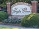 Attractive Taylor Glenn community sign featuring brick, stone, colorful flowers, and lush green landscaping at 1006 Apogee Dr, Indian Trail, NC 28079