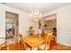 Elegant dining room with hardwood floors, chandelier, and access to other living spaces at 1006 Apogee Dr, Indian Trail, NC 28079