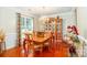 Bright dining room featuring hardwood floors, chandelier, and a decorative china cabinet at 1006 Apogee Dr, Indian Trail, NC 28079
