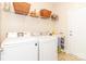 Functional laundry room with washer, dryer, storage shelves, and a folding table at 1006 Apogee Dr, Indian Trail, NC 28079