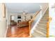 Open living room with a cozy fireplace and staircase, offering an inviting space to relax at 1006 Apogee Dr, Indian Trail, NC 28079
