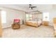 Spacious main bedroom with a four-poster bed, chair, and plenty of natural light at 1006 Apogee Dr, Indian Trail, NC 28079