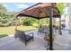Outdoor patio area with an outdoor gazebo, grill, furniture and a lush green lawn at 1006 Apogee Dr, Indian Trail, NC 28079