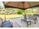 Outdoor patio area with an outdoor gazebo, grill, furniture and a lush green lawn at 1006 Apogee Dr, Indian Trail, NC 28079