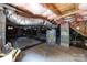 Basement features concrete floor, block foundation, insulation, ductwork, and water heater at 1013 Eaglewood Ave, Charlotte, NC 28212