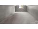 Spacious basement with carpeted floors and natural light, perfect for storage or a workshop at 1013 Eaglewood Ave, Charlotte, NC 28212