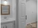 Bathroom featuring vanity, mirror, with tile countertop, cabinets, lighting, and doorway at 1013 Eaglewood Ave, Charlotte, NC 28212