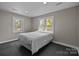 This bedroom has neutral walls and carpet with windows providing natural light at 1013 Eaglewood Ave, Charlotte, NC 28212