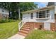 Front entrance features brick steps, white railing, and brick foundation at 1013 Eaglewood Ave, Charlotte, NC 28212