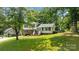 Inviting two-story home featuring a lush front lawn and a charming brick and white facade at 1013 Eaglewood Ave, Charlotte, NC 28212