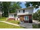 Charming two-story house with mixed siding, lush lawn, and a welcoming front entrance at 1013 Eaglewood Ave, Charlotte, NC 28212
