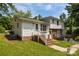 A beautiful view of the home's exterior, lush lawn, brick features, and a white siding at 1013 Eaglewood Ave, Charlotte, NC 28212