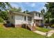Charming white home with brick foundation and staircase leading to a welcoming entrance at 1013 Eaglewood Ave, Charlotte, NC 28212