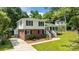 Charming two-story home with brick and white siding, black shutters, and inviting front yard at 1013 Eaglewood Ave, Charlotte, NC 28212