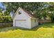 Detached white garage featuring a gable roof and a double-wide door for vehicle storage at 1013 Eaglewood Ave, Charlotte, NC 28212