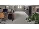 This is a virtually staged picture of the home office with hardwood desk, shelf, and decor at 1013 Eaglewood Ave, Charlotte, NC 28212
