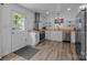 Modern kitchen with white cabinets, stainless steel appliances, and hardwood floors at 1013 Eaglewood Ave, Charlotte, NC 28212