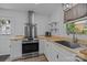 Modern kitchen with stainless steel appliances, light wood countertops, and white cabinets at 1013 Eaglewood Ave, Charlotte, NC 28212