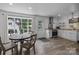 Modern eat-in kitchen featuring white cabinets, stainless steel appliances, wood countertops and hardwood floors at 1013 Eaglewood Ave, Charlotte, NC 28212