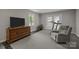 Comfortable sitting area with treadmill, gray walls and carpet at 1013 Eaglewood Ave, Charlotte, NC 28212