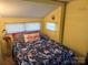 Bedroom features a double bed with floral bedding, flamingo themed decor, and lighting at 104 Deer Park Rd # D143, Mount Gilead, NC 27306