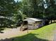 Home with a large covered porch surrounded by trees at 104 Deer Park Rd # D143, Mount Gilead, NC 27306
