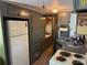 The kitchen features a white refrigerator, sink, stove and gray cabinets for storage at 104 Deer Park Rd # D143, Mount Gilead, NC 27306
