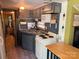 Efficient kitchen design with oven, microwave, sink, and ample cabinet storage at 104 Deer Park Rd # D143, Mount Gilead, NC 27306
