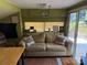 Cozy living room features a comfortable couch, camper decor, and sliding glass doors to the outside at 104 Deer Park Rd # D143, Mount Gilead, NC 27306