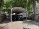 Covered parking area with multiple golf carts at 104 Deer Park Rd # D143, Mount Gilead, NC 27306