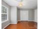 Spacious, bright bedroom with gleaming hardwood floors, large windows, and ample closet space at 10446 Trolley Run Dr, Cornelius, NC 28031
