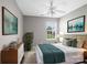 A charming bedroom featuring neutral walls, a ceiling fan, and a view from the window at 10446 Trolley Run Dr, Cornelius, NC 28031