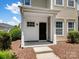 Exterior view of the front door with covered entryway and manicured landscaping at 10446 Trolley Run Dr, Cornelius, NC 28031