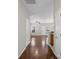 Hallway with hardwood floors leading to multiple rooms, providing a clear and connected layout at 10446 Trolley Run Dr, Cornelius, NC 28031