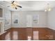 Bright living room features hardwood floors and multiple windows at 10446 Trolley Run Dr, Cornelius, NC 28031